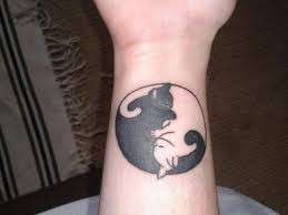 Tatuaggio con due gatti, uno bianco e uno nero